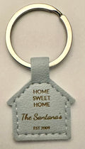 House-shaped light blue faux leather keychain laser engraved with Home Sweet Home The Santanas Est 2009