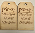 Laser-engraved basswood gift tags reading Pairs Well With A New Home and Pairs Well With A Sold Home