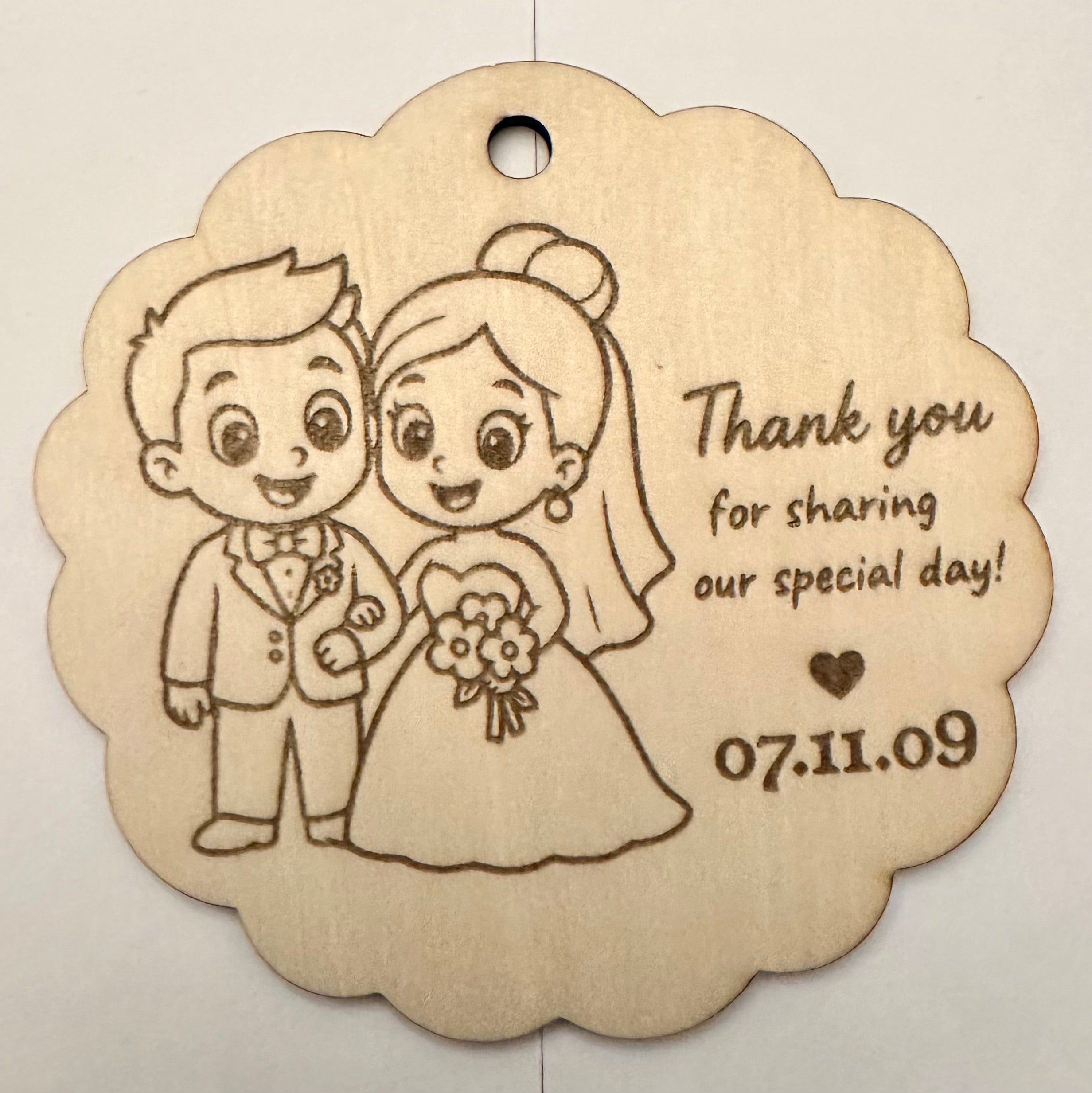 Laser-engraved basswood wedding favor tag with cartoon bride and groom and text Thank you for sharing our special day